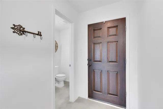 a bathroom with a sink vanity mirror and toilet