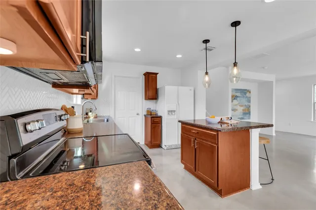 a kitchen with stainless steel appliances a sink stove and cabinets