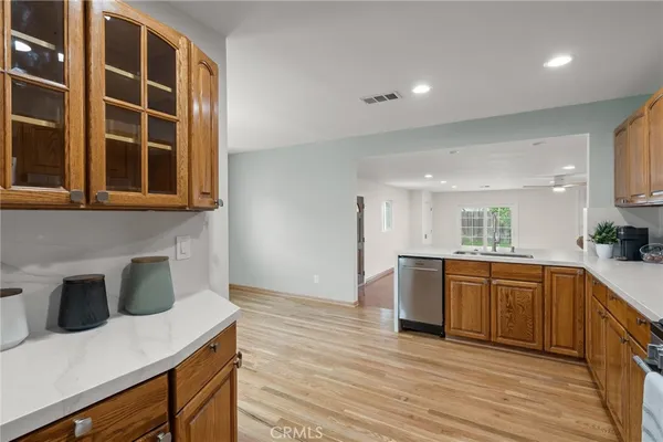 a kitchen with stainless steel appliances kitchen island granite countertop a sink and cabinets