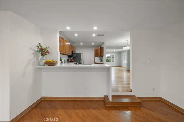 a view of kitchen with stainless steel appliances cabinets