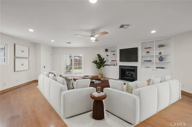 a living room with furniture a fireplace and a flat screen tv