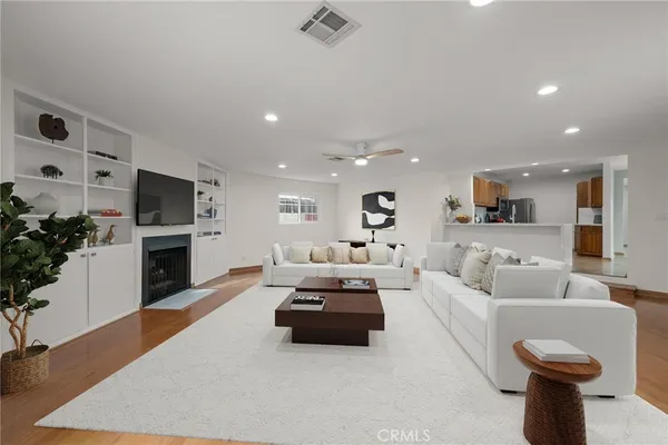 a living room with furniture a fireplace and a flat screen tv
