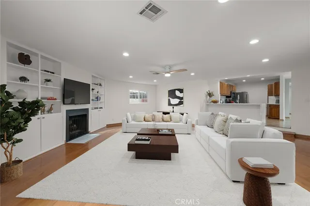 a living room with furniture a fireplace and a flat screen tv