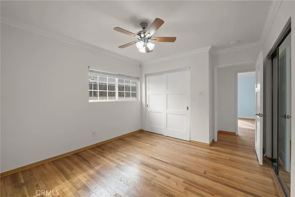a view of a livingroom with a ceiling fan and wooden floor