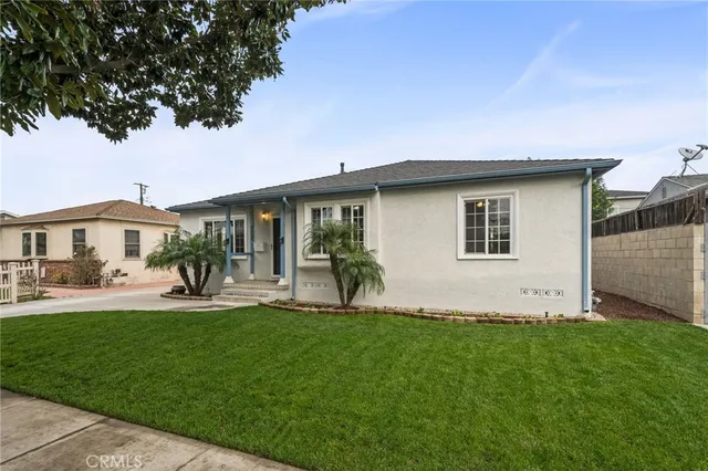 a front view of a house with a yard and porch