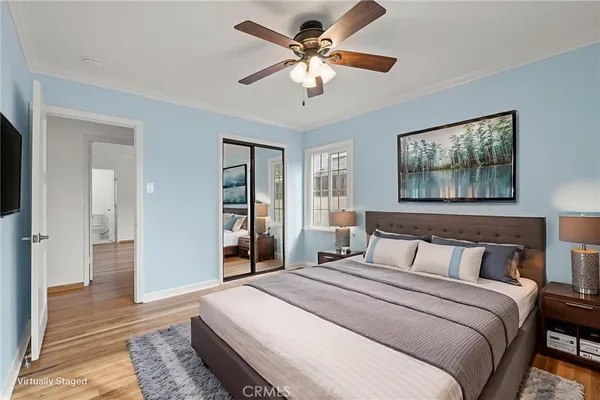 a bedroom with a large bed a chandelier and closet