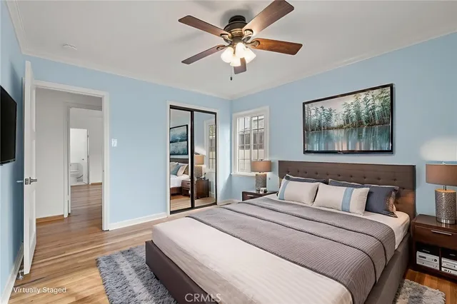 a bedroom with a large bed a chandelier and closet