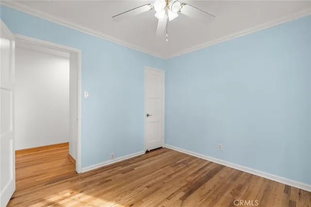 a view of a room with wooden floor and fan