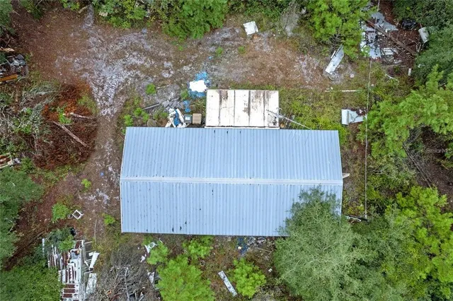 a backyard of a house with a garden and plants