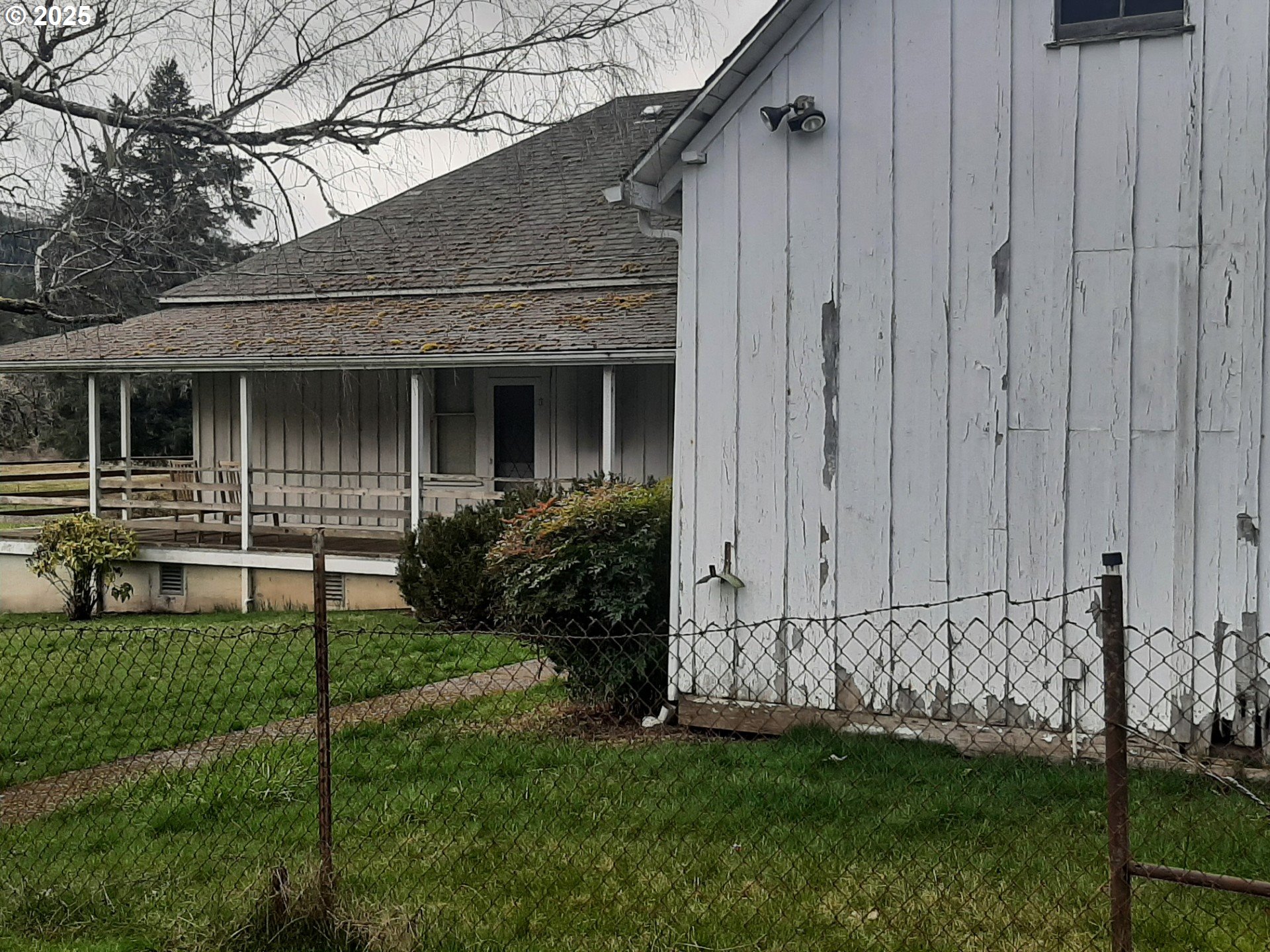 39935 Layng Creek Road Dorena, OR 97434 - Photo 5 of 11 a view of a house with a small yard and wooden fence