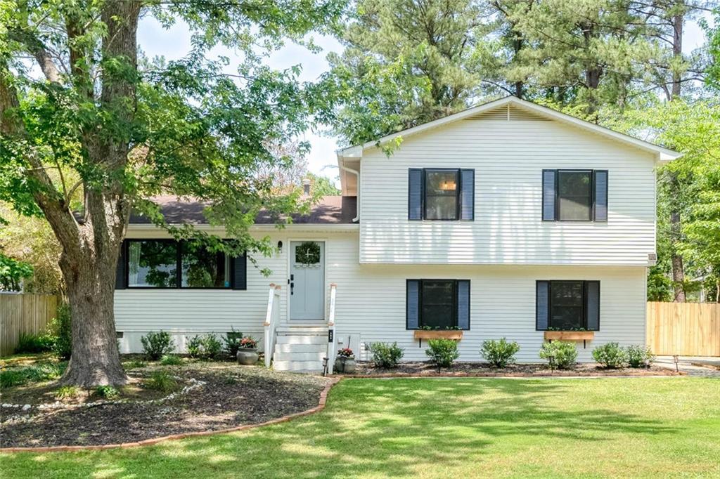 595 Westchester Circle Southwest Marietta, GA 30064 - Photo 1 of 1 a house that has a tree in front of the house