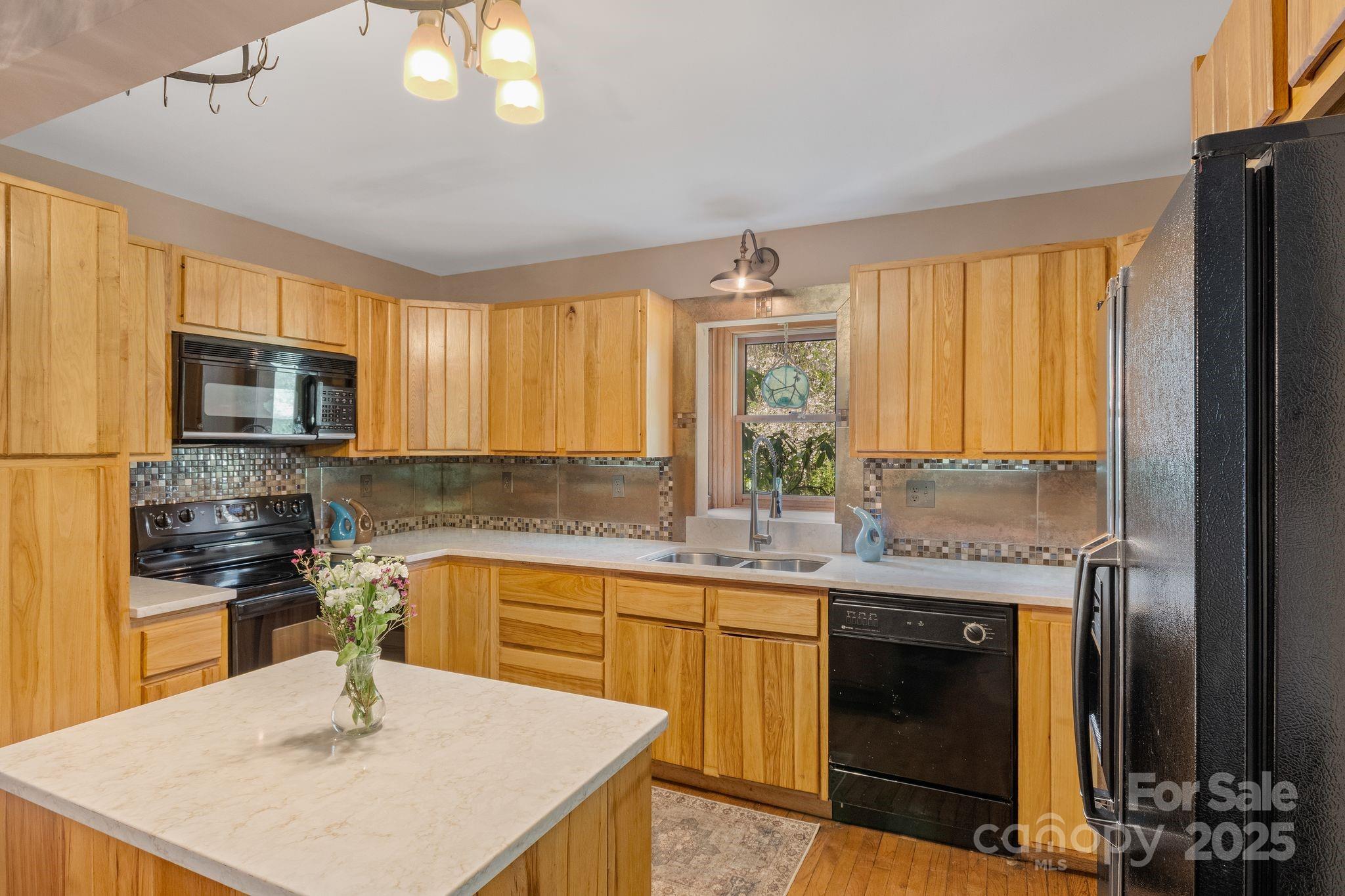 22 Morgan Branch Road Weaverville, NC 28787 - Photo 13 of 47 a kitchen with a sink a stove and chairs