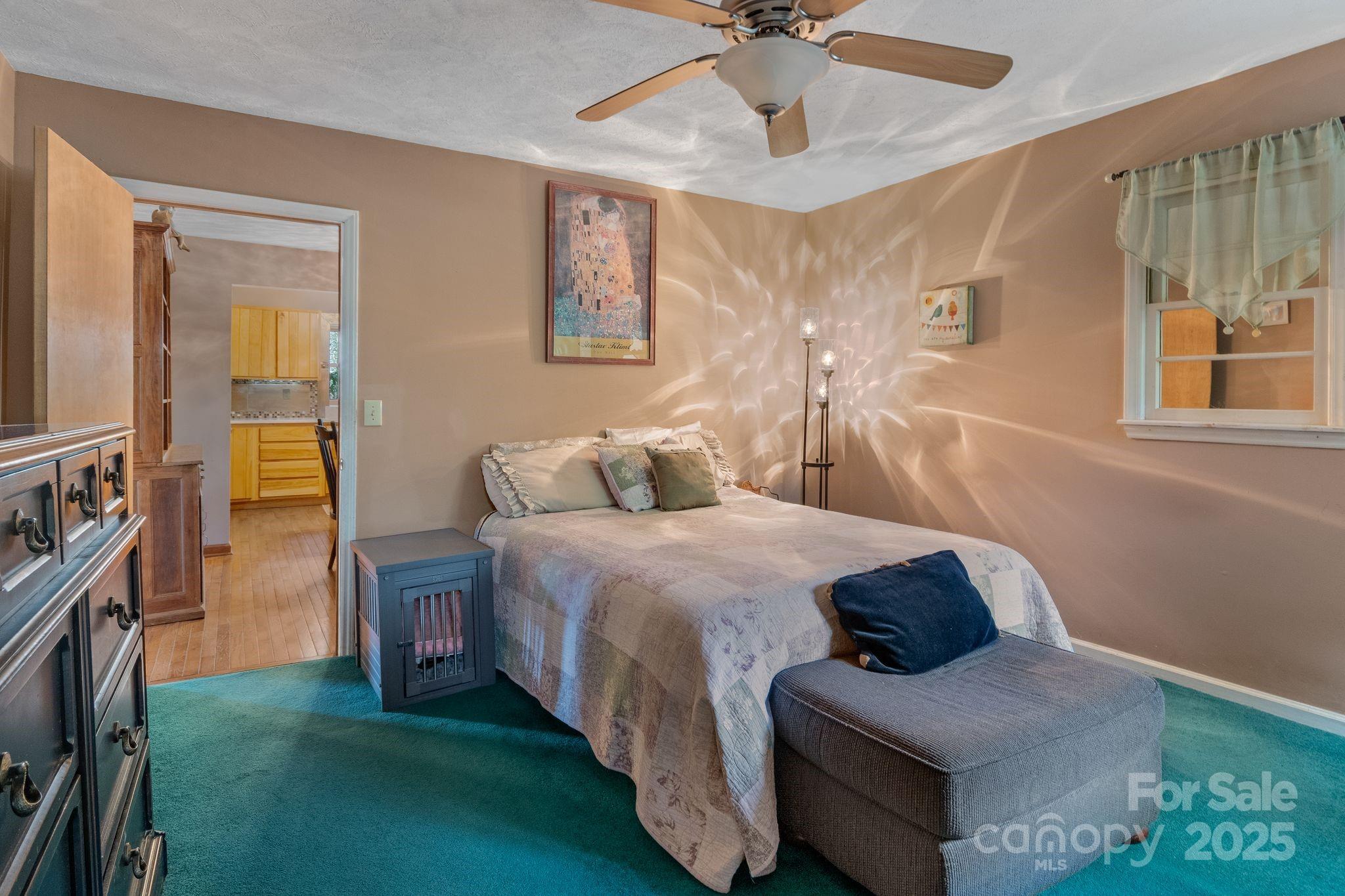 22 Morgan Branch Road Weaverville, NC 28787 - Photo 22 of 47 a bedroom with a bed and a chandelier