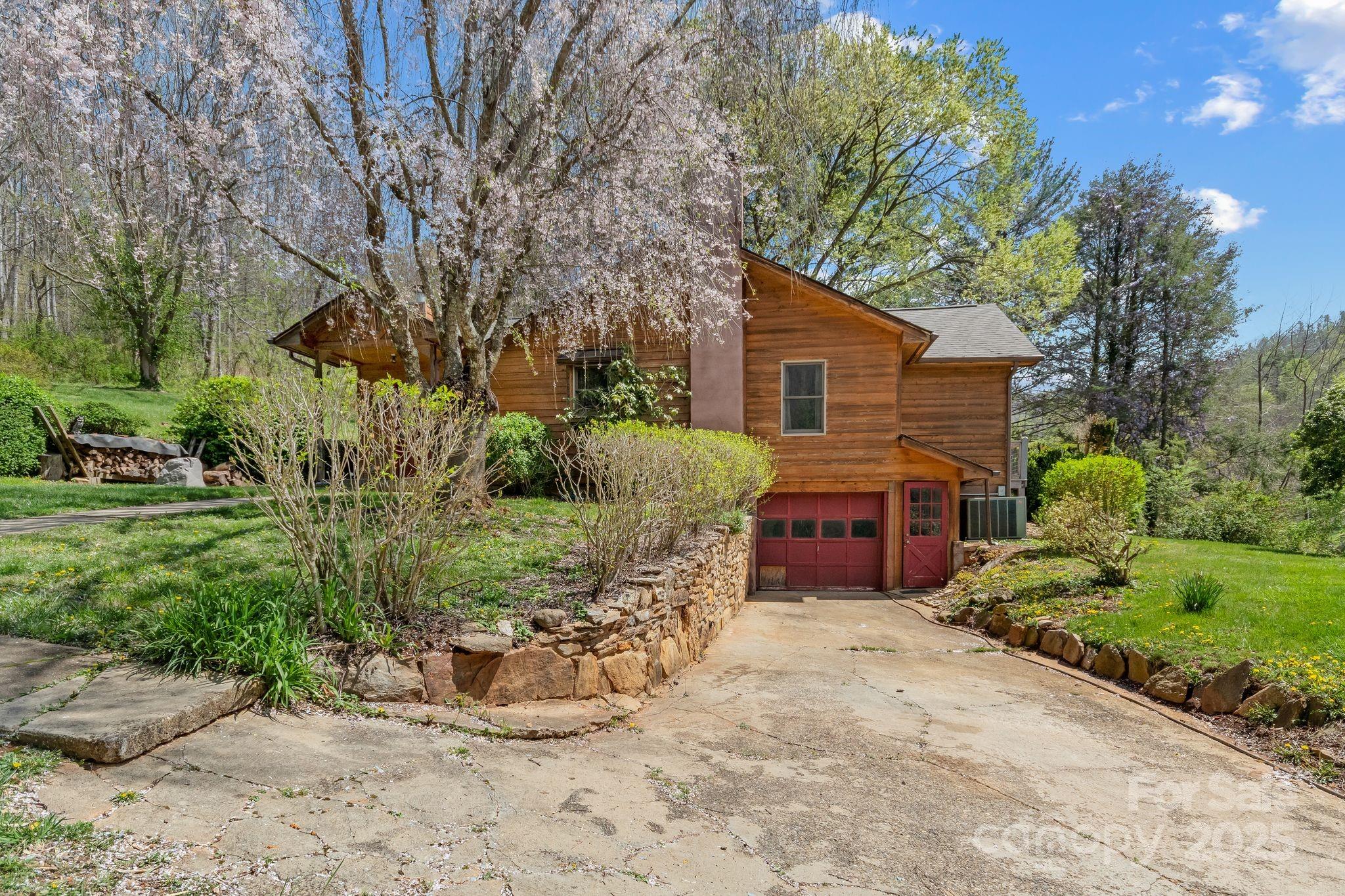 22 Morgan Branch Road Weaverville, NC 28787 - Photo 3 of 47 a front view of a house with a yard and garage