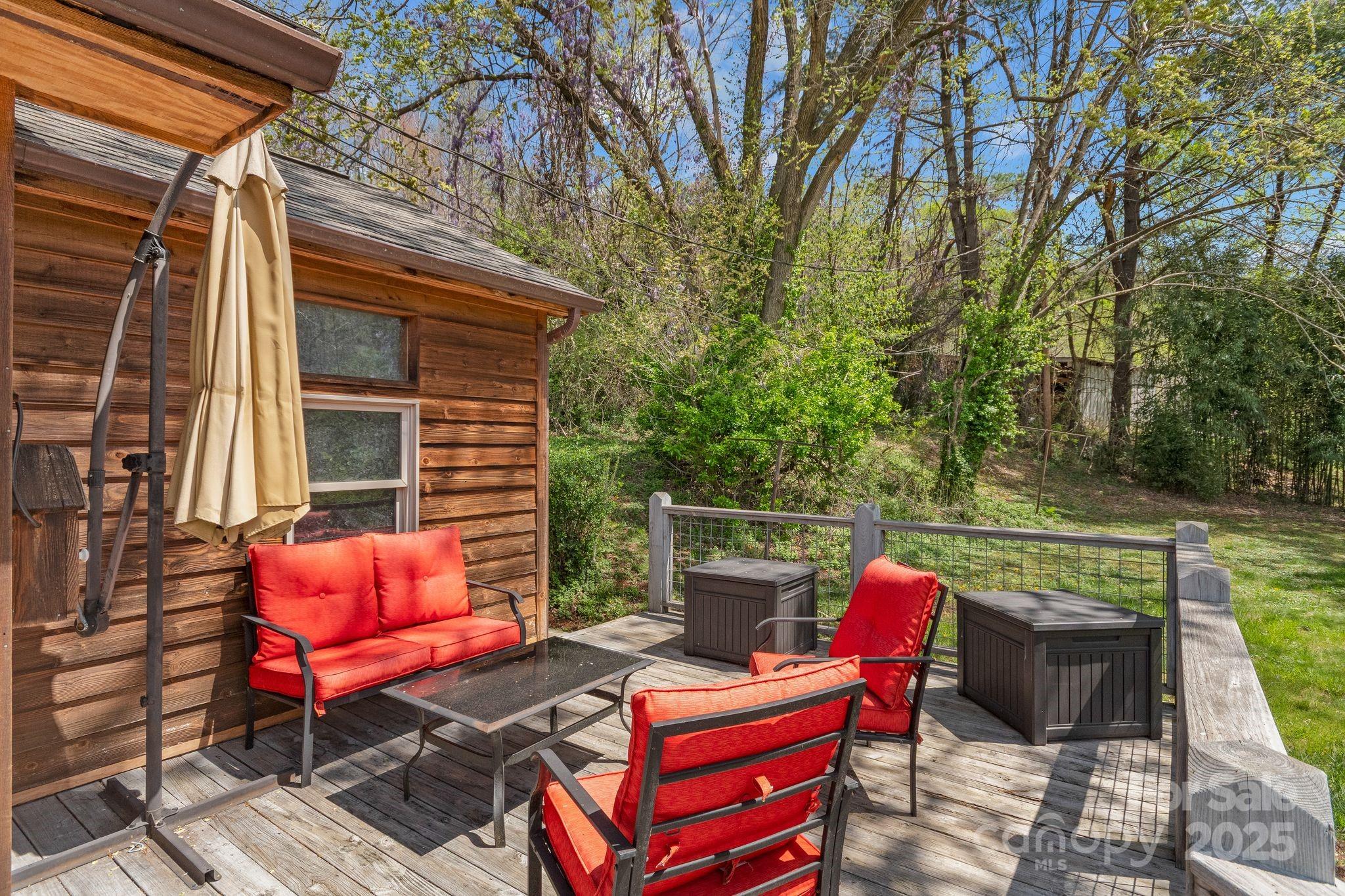 22 Morgan Branch Road Weaverville, NC 28787 - Photo 33 of 47 a roof deck with a bench and potted plants