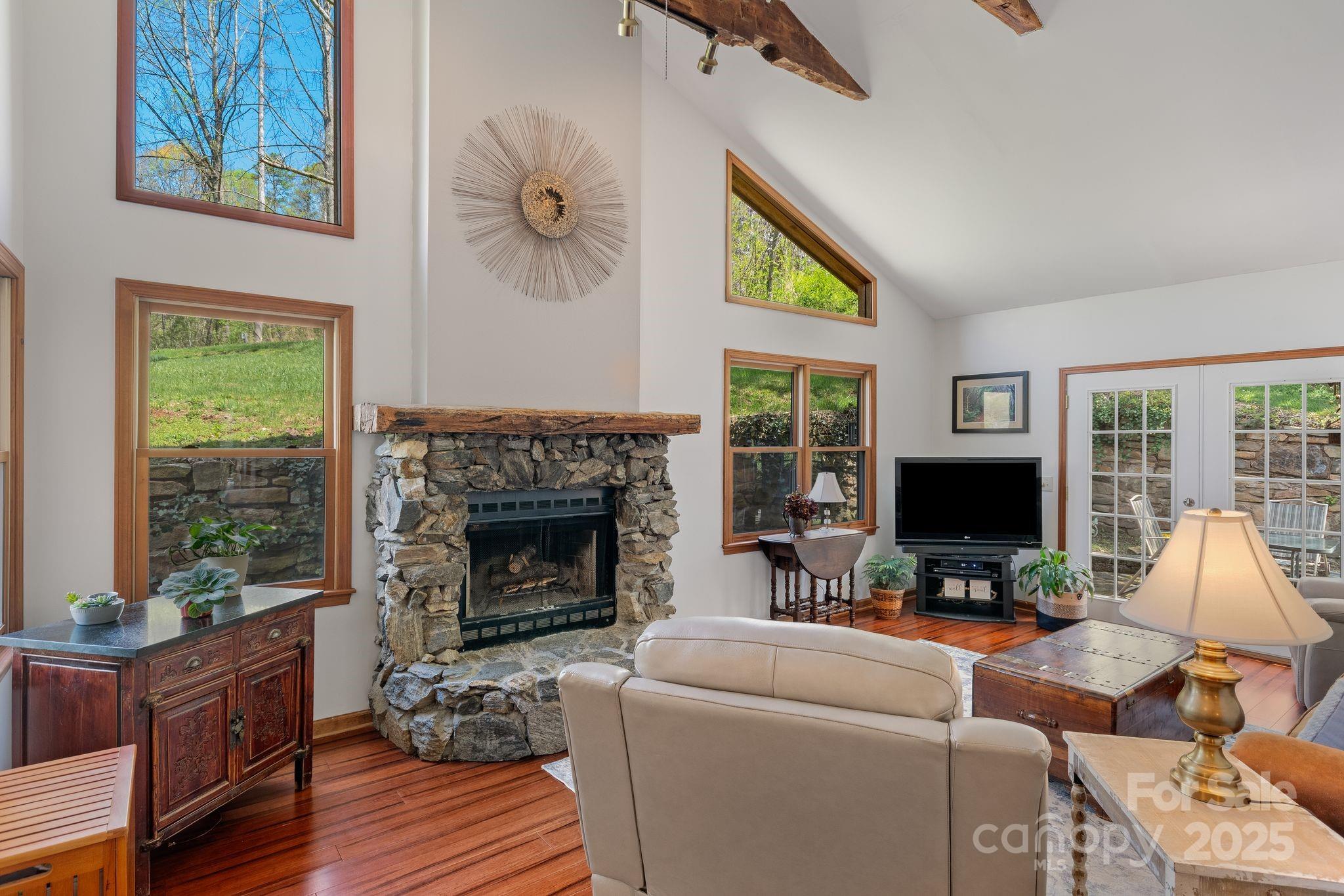 22 Morgan Branch Road Weaverville, NC 28787 - Photo 8 of 47 a living room with furniture a fireplace and a flat screen tv