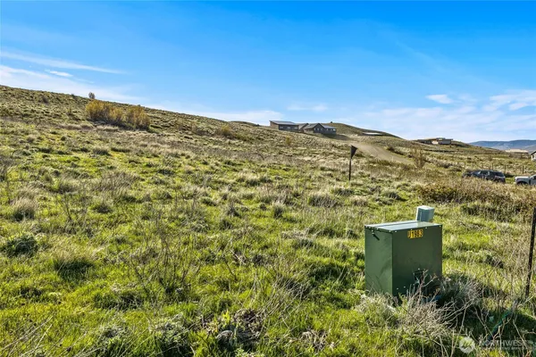 a view of a large building with mountains in the background