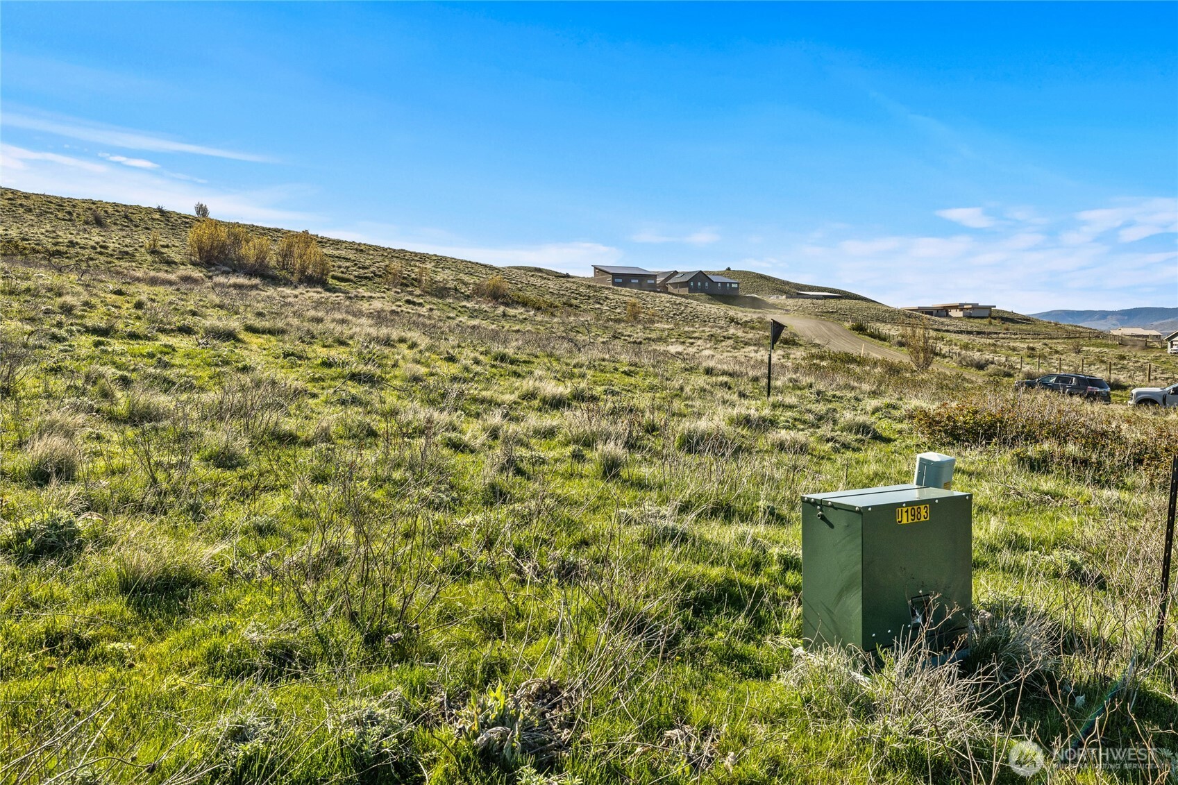 9 Ellensburg Ranches Road Ellensburg, WA 98926 - Photo 5 of 14 a view of a large building with mountains in the background