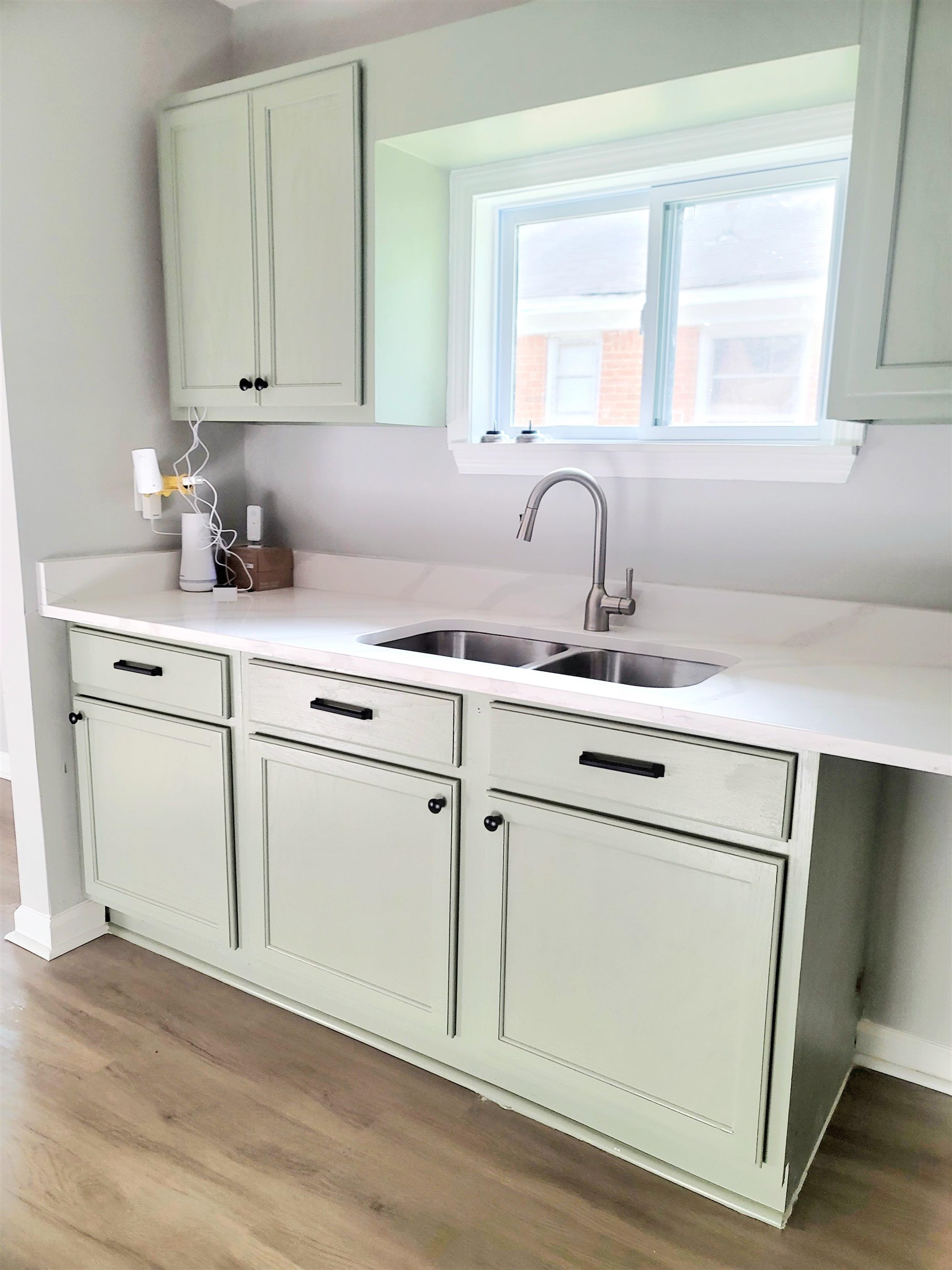 1434 Eloise Road Memphis, TN 38106 - Photo 7 of 19 a kitchen with cabinets appliances a sink and a window