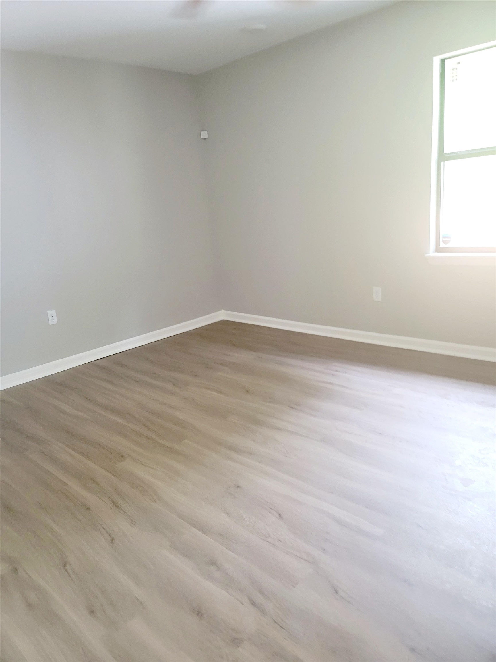 1434 Eloise Road Memphis, TN 38106 - Photo 9 of 19 an empty room with wooden floor and windows