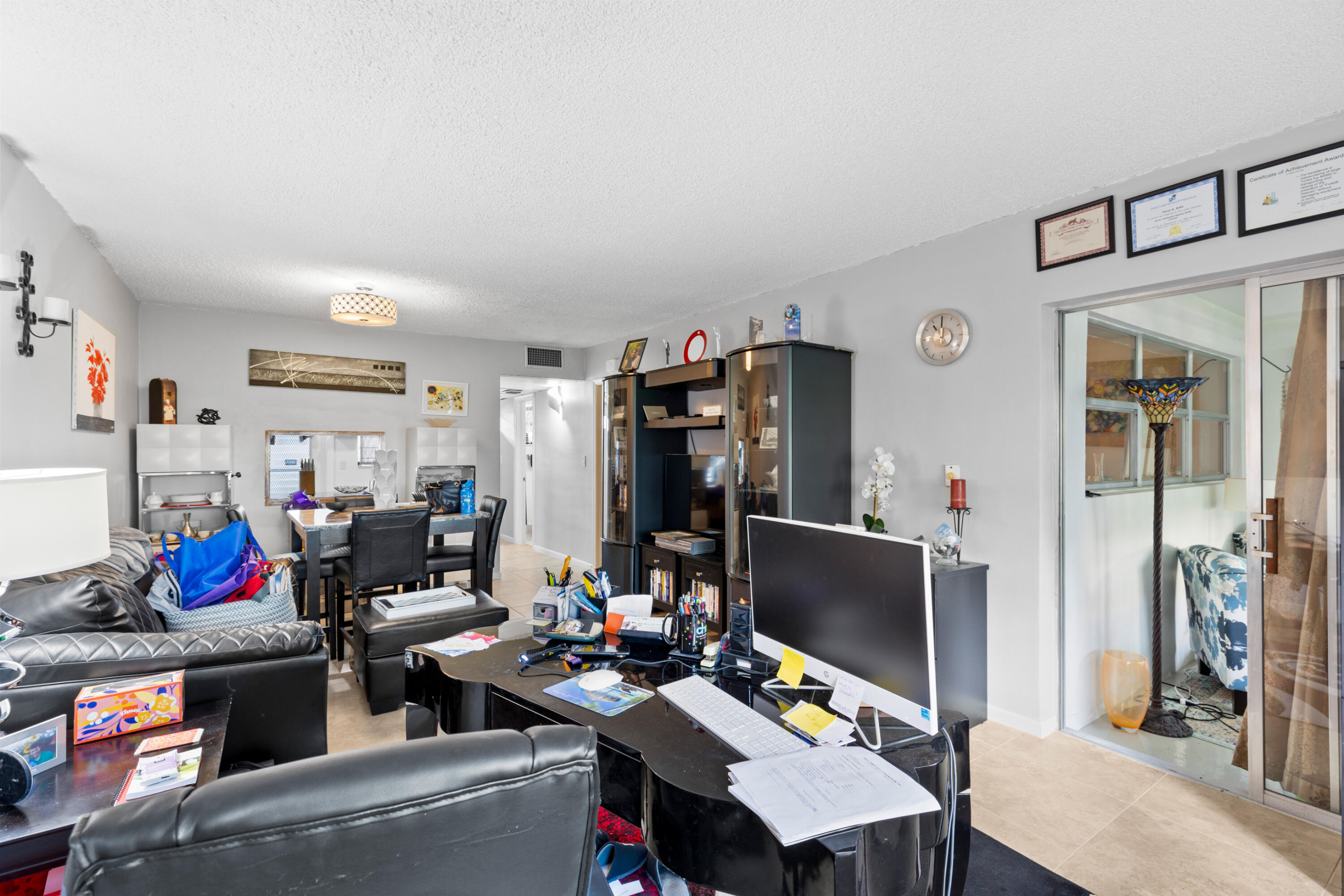 400 Northeast 20th Street, Unit B108 Boca Raton, FL 33431 - Photo 13 of 31 a living room with furniture and a flat screen tv