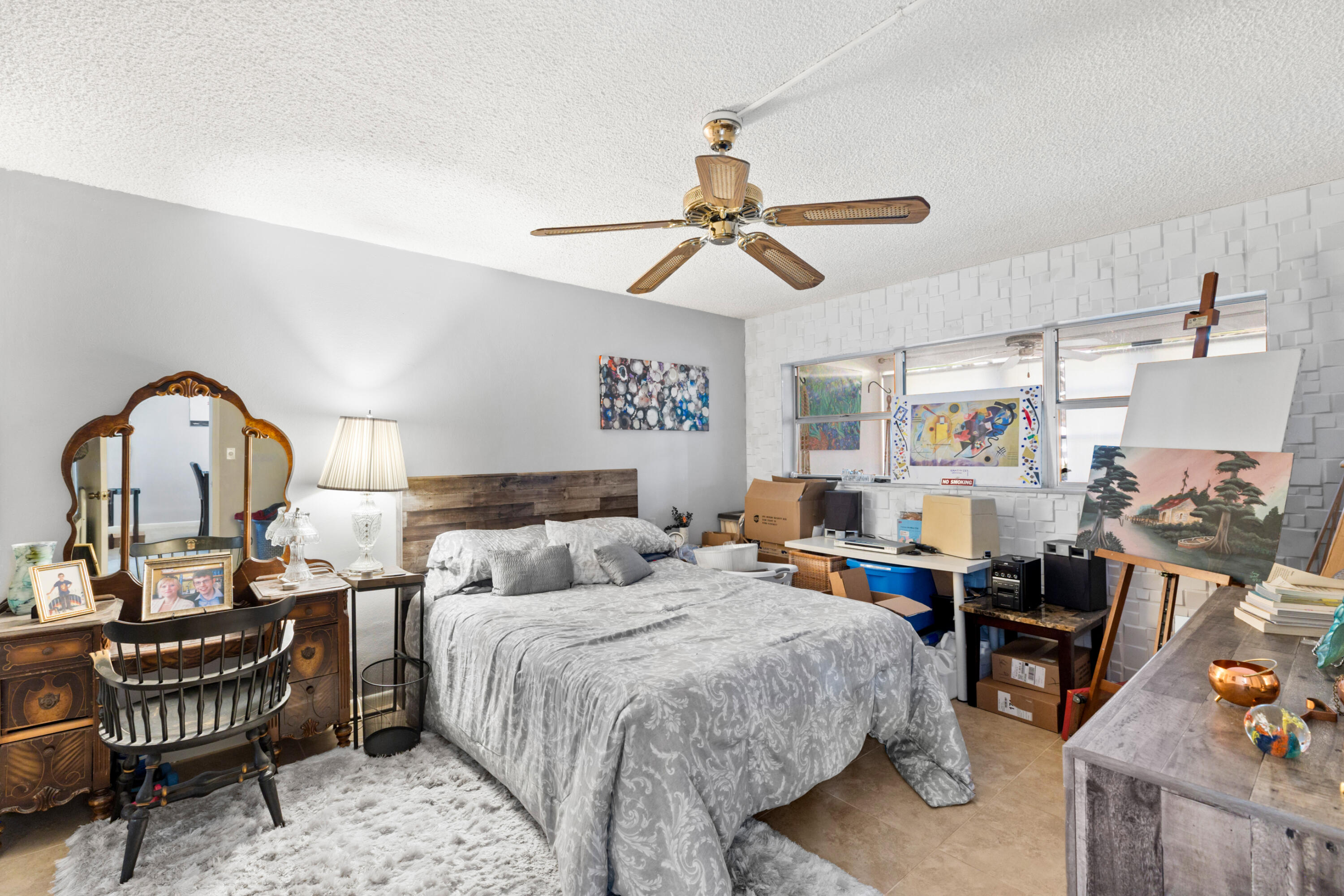 400 Northeast 20th Street, Unit B108 Boca Raton, FL 33431 - Photo 15 of 31 a bedroom with a bed and a chandelier