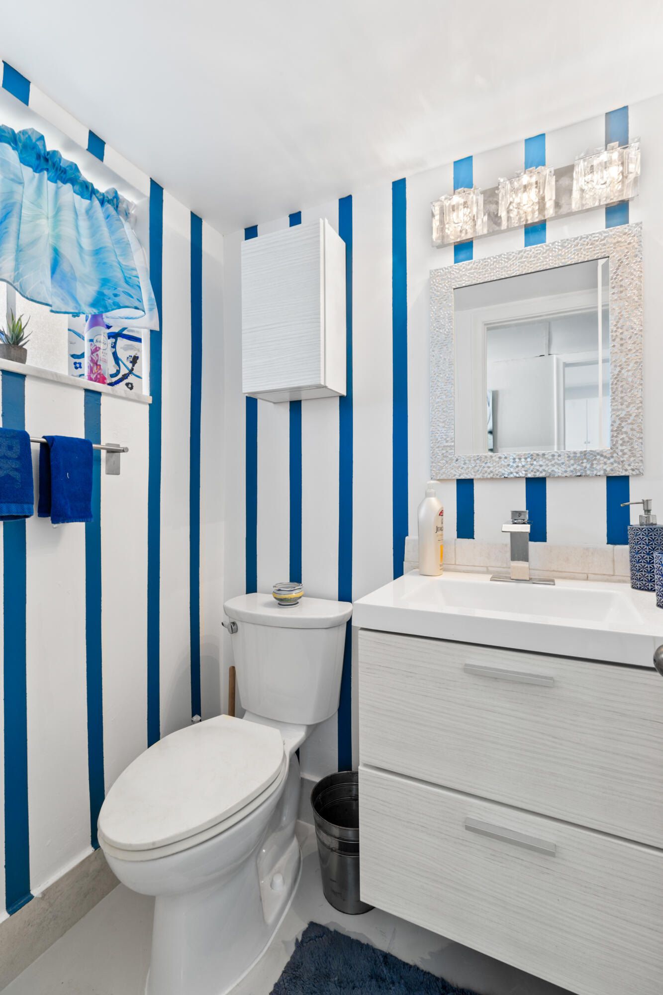 400 Northeast 20th Street, Unit B108 Boca Raton, FL 33431 - Photo 16 of 31 a bathroom with a sink a toilet and a shower