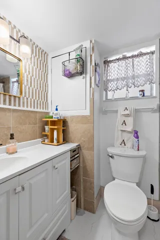 a bathroom with a sink toilet and a mirror