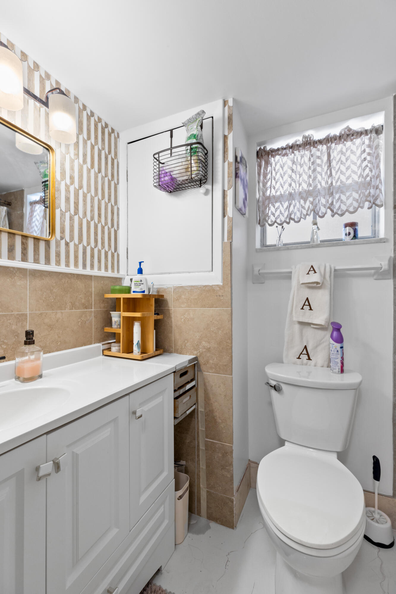 400 Northeast 20th Street, Unit B108 Boca Raton, FL 33431 - Photo 17 of 31 a bathroom with a sink toilet and a mirror