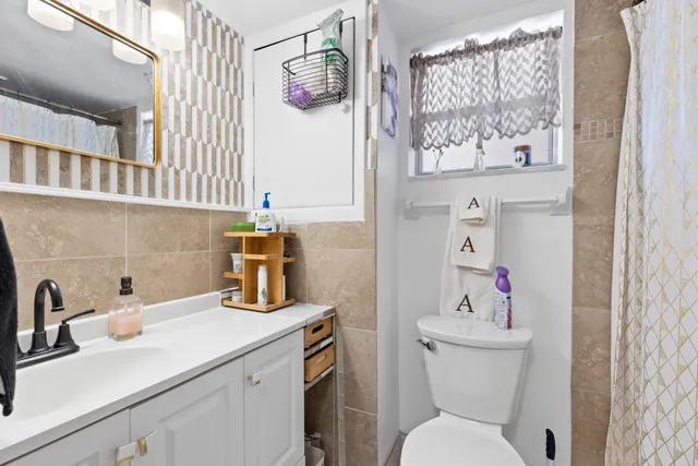 a bathroom with a sink toilet and mirror