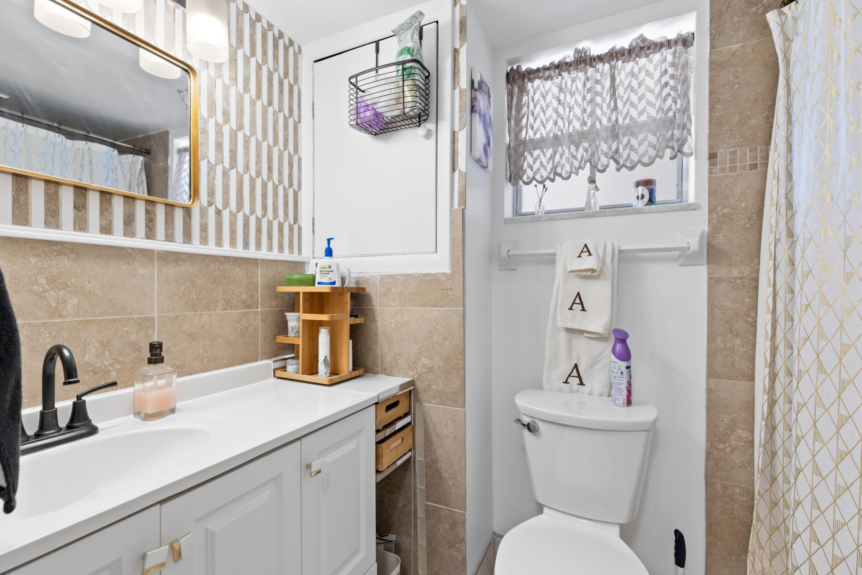 400 Northeast 20th Street, Unit B108 Boca Raton, FL 33431 - Photo 18 of 31 a bathroom with a sink toilet and mirror