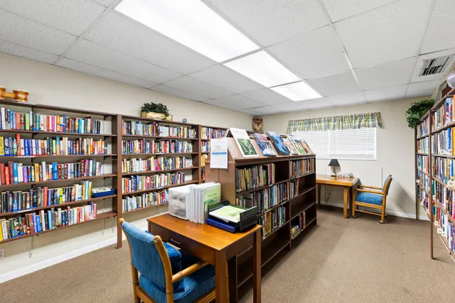 a room with furniture a baby crib and a book shelf