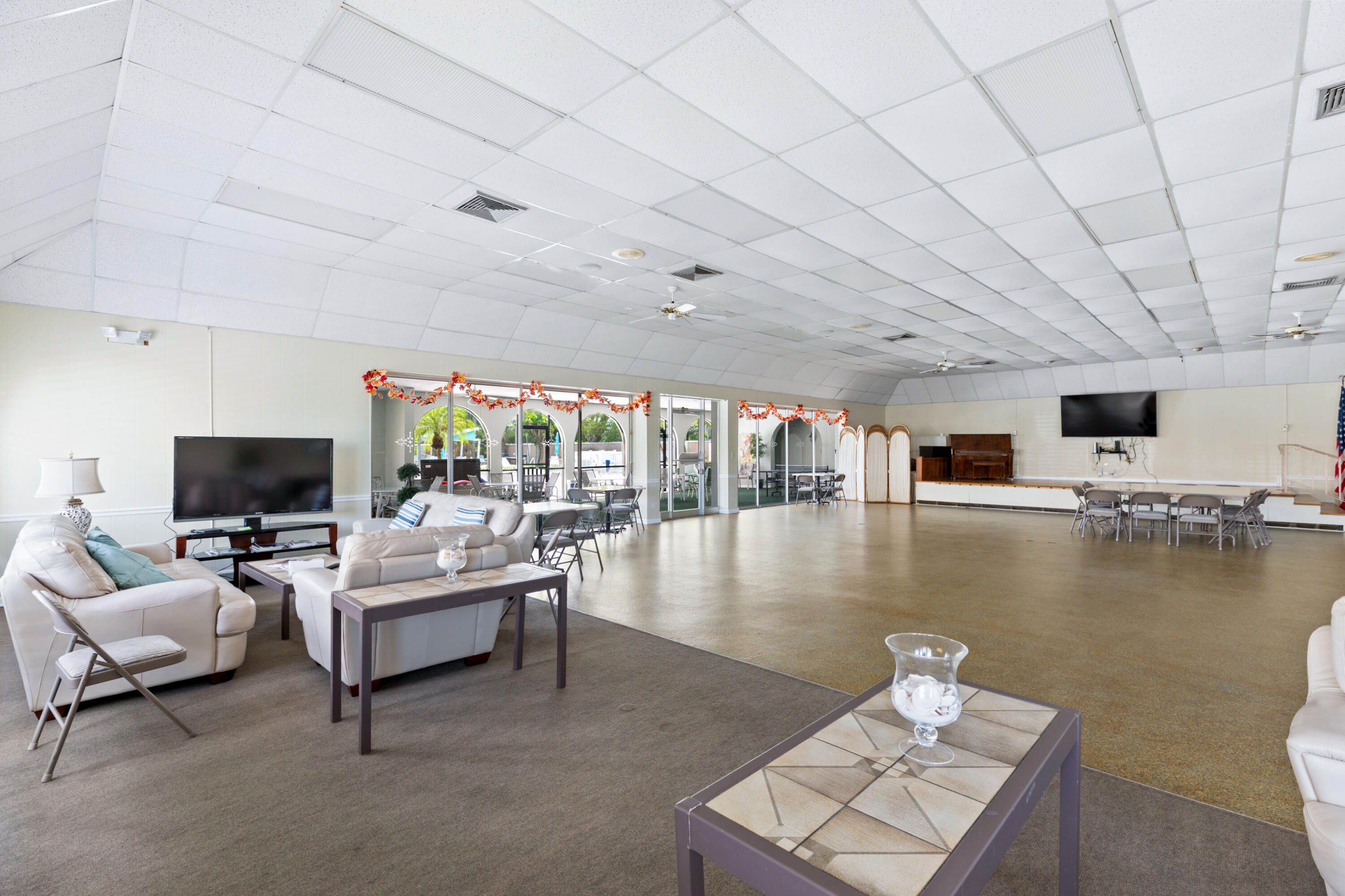 400 Northeast 20th Street, Unit B108 Boca Raton, FL 33431 - Photo 29 of 31 a living room with furniture and a flat screen tv