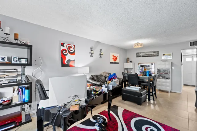 a room with furniture a rug and a book shelf