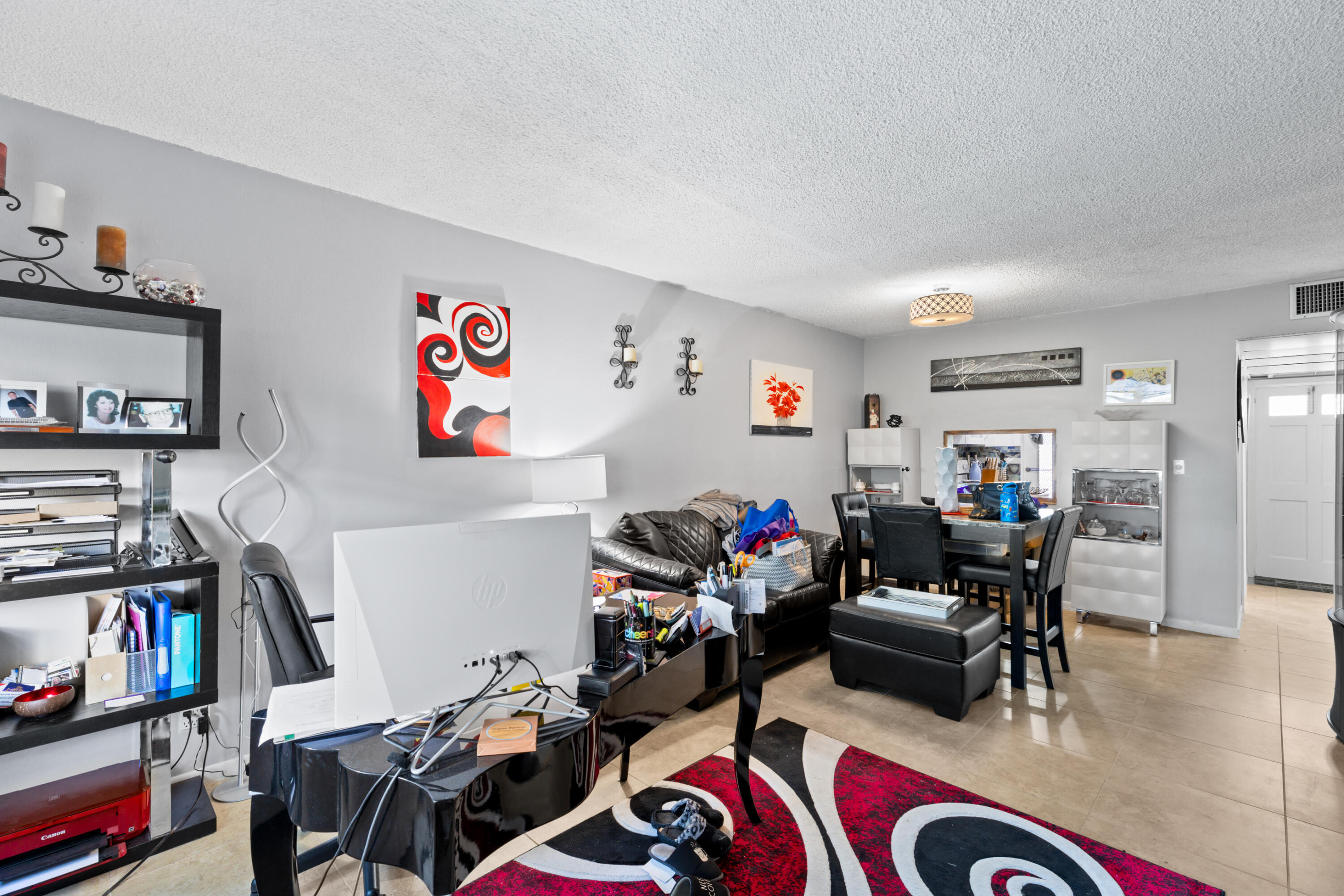 400 Northeast 20th Street, Unit B108 Boca Raton, FL 33431 - Photo 10 of 31 a room with furniture a rug and a book shelf