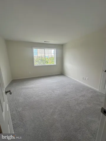 a room with white cabinets and a wooden floor