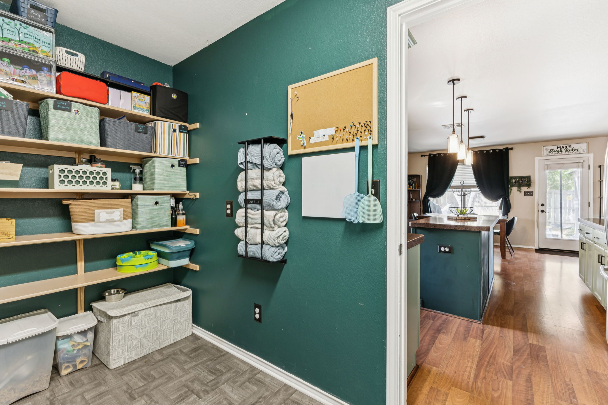2412 Chestnut Path Round Rock, TX 78664 - Photo 10 of 26 Organized utility space with shelving offers easy access to essentials, adjacent to a brightly lit kitchen.