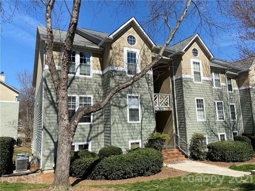 19839 Henderson Road, Unit A Cornelius, NC 28031 - Photo 2 of 23 a front view of a house with a yard