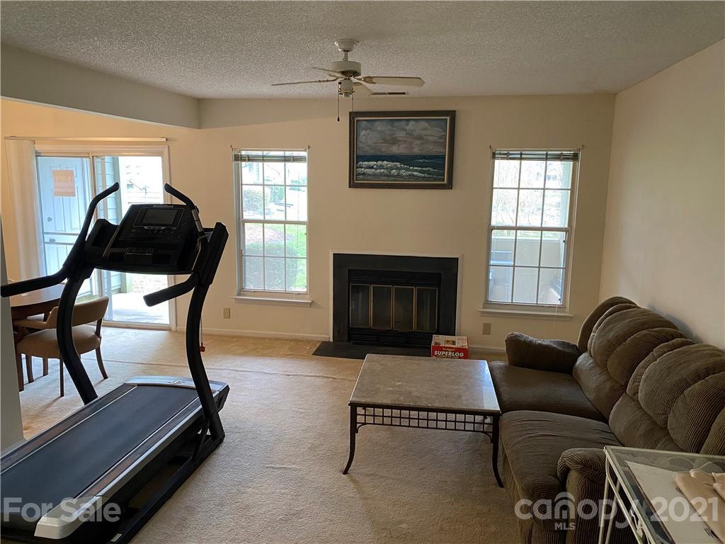 19839 Henderson Road, Unit A Cornelius, NC 28031 - Photo 11 of 23 a living room with furniture and a fireplace