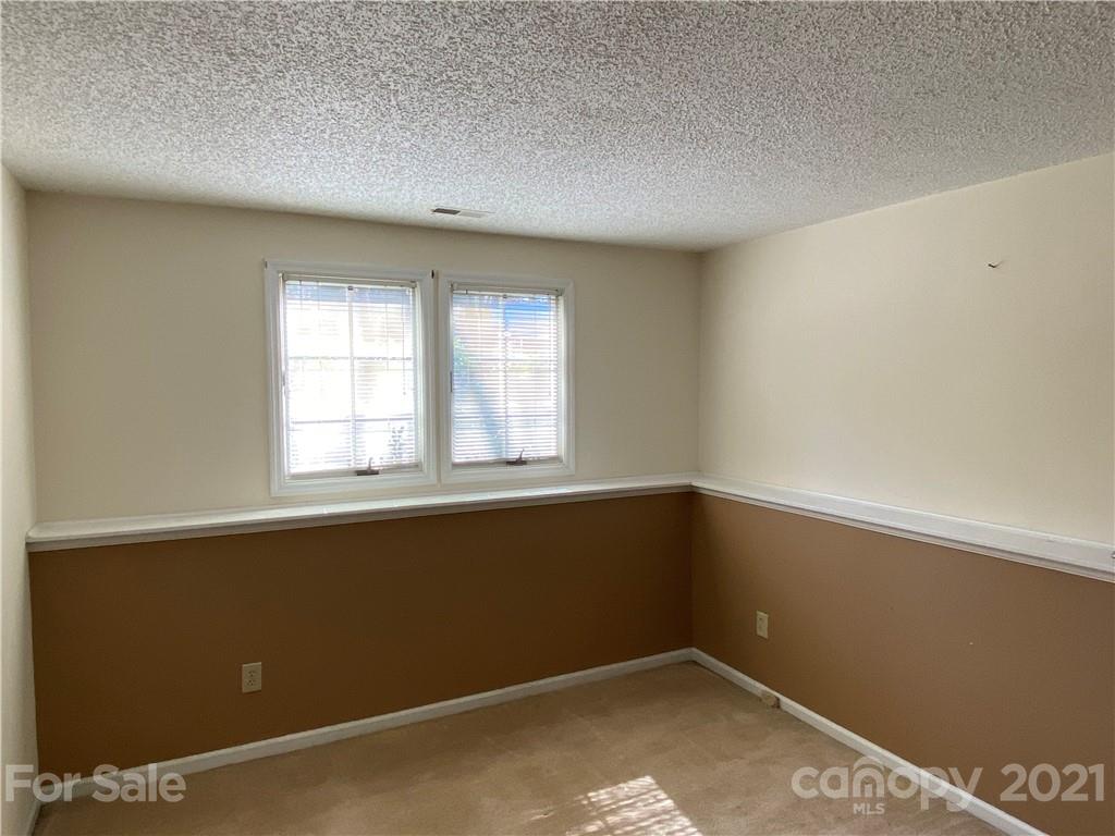 19839 Henderson Road, Unit A Cornelius, NC 28031 - Photo 13 of 23 an empty room with windows