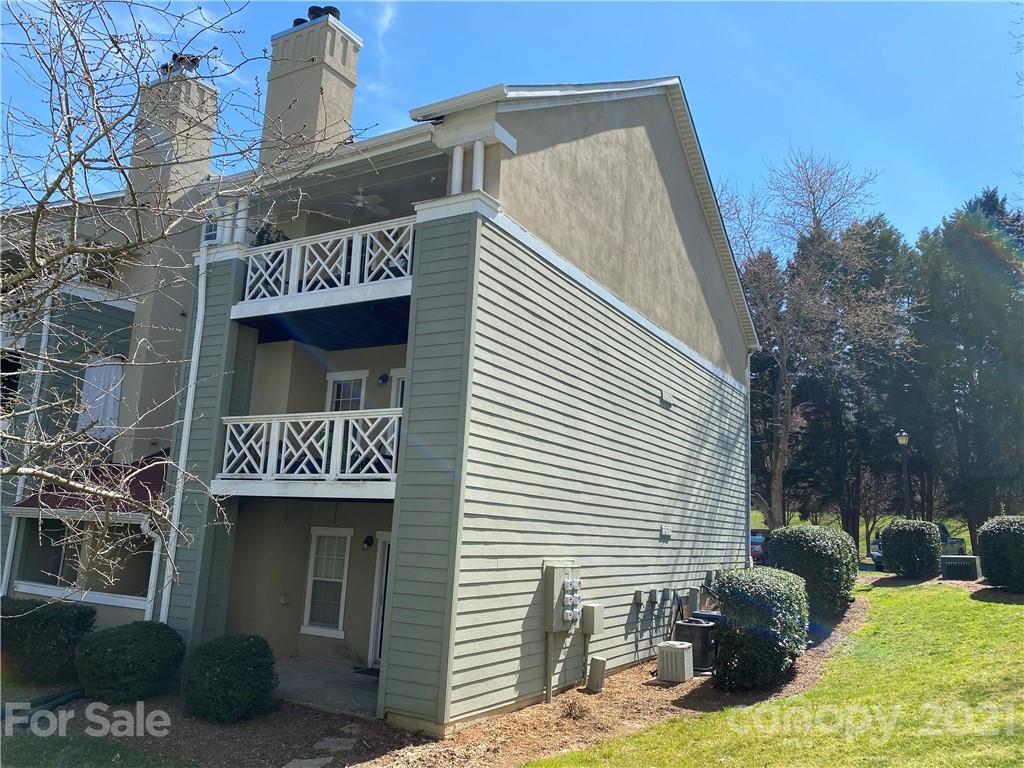 19839 Henderson Road, Unit A Cornelius, NC 28031 - Photo 17 of 23 a front view of multi story residential apartment building with yard