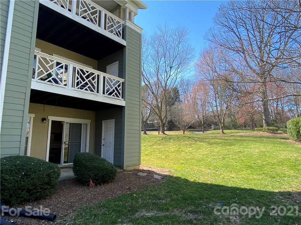 19839 Henderson Road, Unit A Cornelius, NC 28031 - Photo 18 of 23 a view of a house with a yard and potted plants