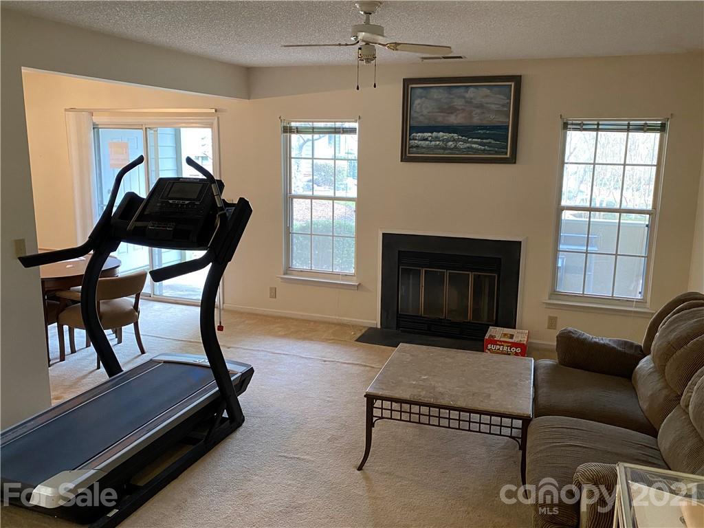 19839 Henderson Road, Unit A Cornelius, NC 28031 - Photo 7 of 23 a living room with furniture and a fireplace