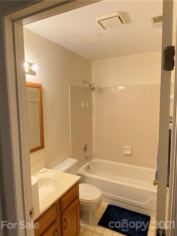 19839 Henderson Road, Unit A Cornelius, NC 28031 - Photo 10 of 23 a bathroom with a granite countertop sink toilet and shower