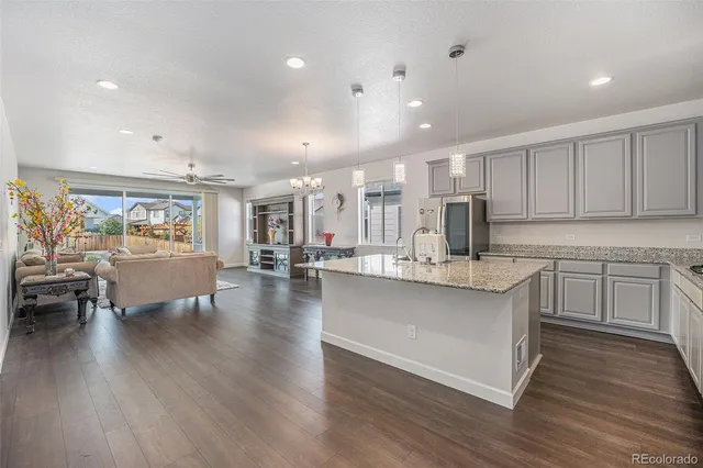 a large white kitchen with lots of counter space a sink and appliances