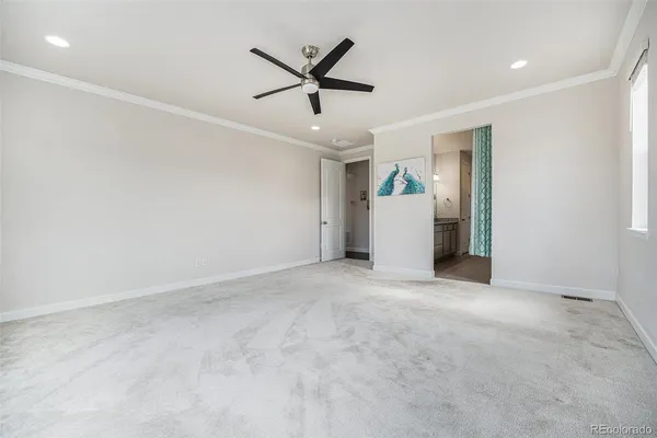 a view of a livingroom with a ceiling fan and window