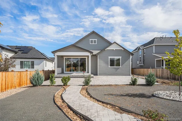 a front view of a house with a yard fountain and a tree