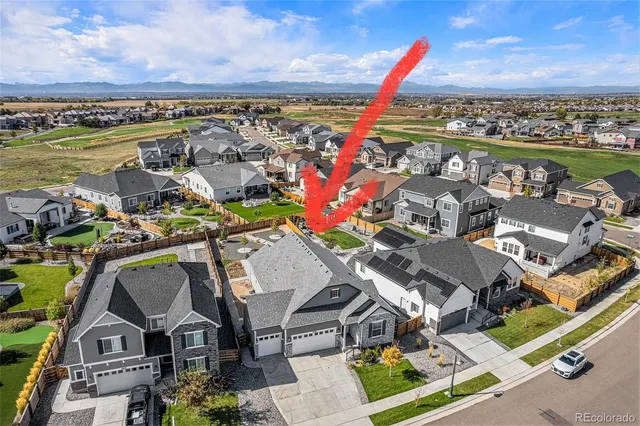 an aerial view of a house with outdoor seating