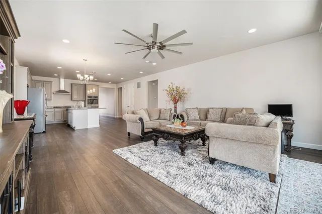 a living room with furniture and kitchen view