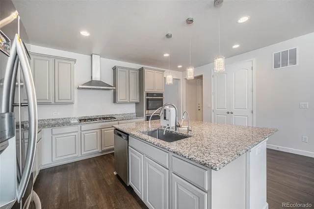 a kitchen with stainless steel appliances granite countertop refrigerator sink and cabinets